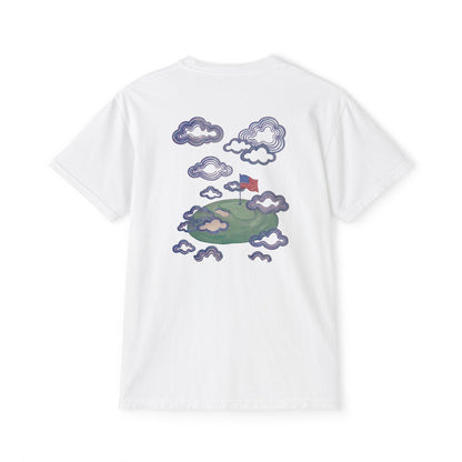 Back of white tee — hand-painted American flag planted on a floating green island among clouds